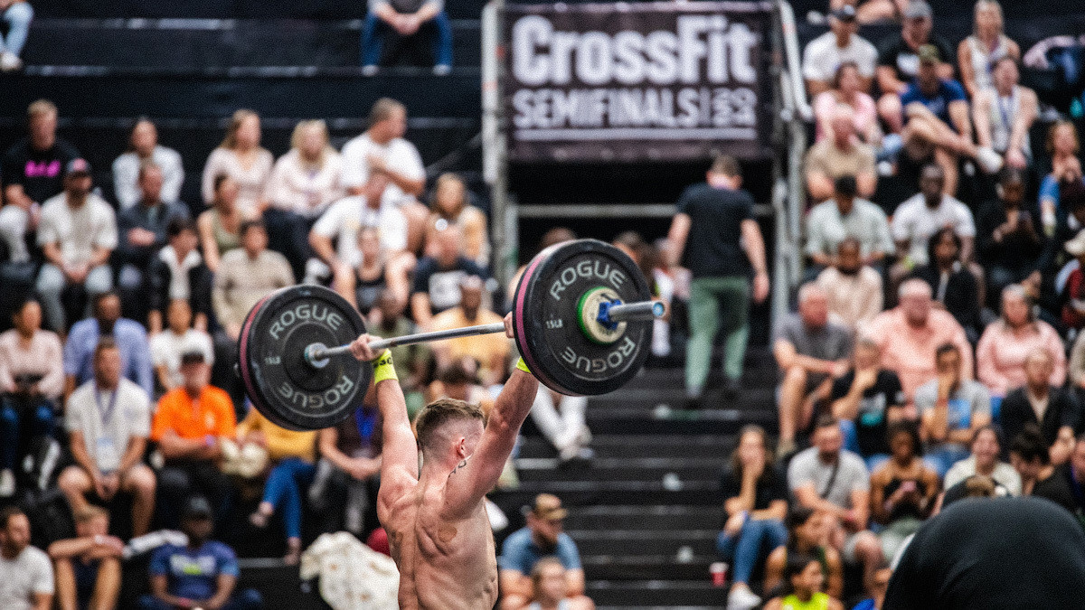 The 2026 CrossFit Semifinals Dates And Details Athlete With Barbell Overhead At The Rebel Reneage Games In 2024 FXD 